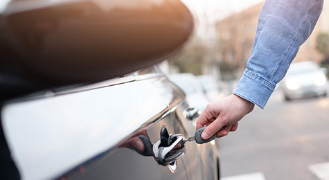 Opening up the trunk of a car.