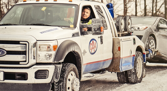 Tow truck with car in winter