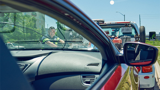 Tow truck driver look through the window spring.