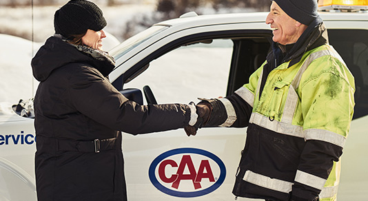 Tow truck driver shaking hands with a woman