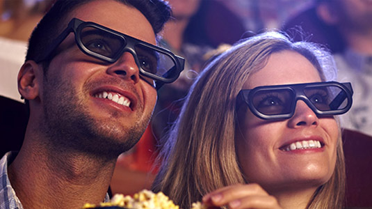 Couple eating popcorn and watching a movie