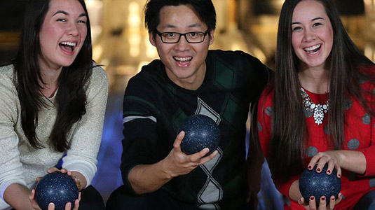 Friends holding bowling balls