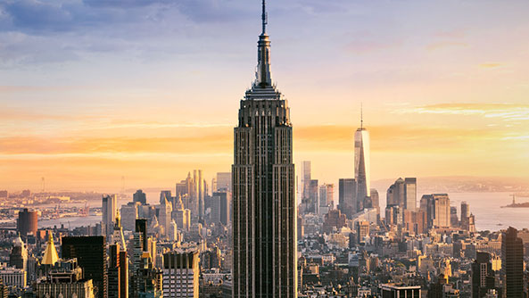 Empire State Building with sunset in background.