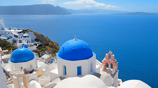 Aerial shot of the blue domes of Oia in Santorini