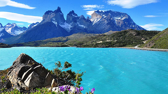 Glacial lake and mountains under a blue sky.