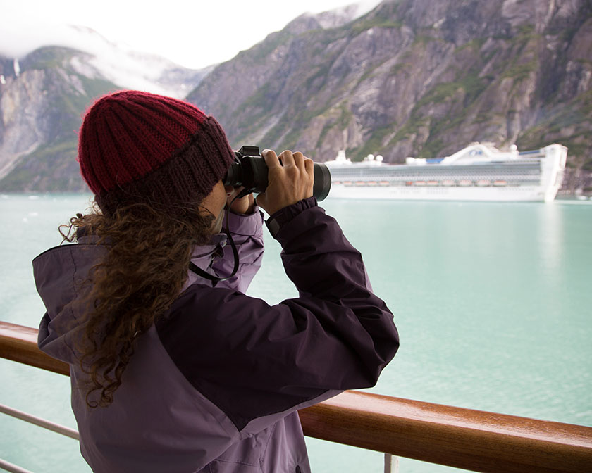 Woman on cruise deck with binoculars