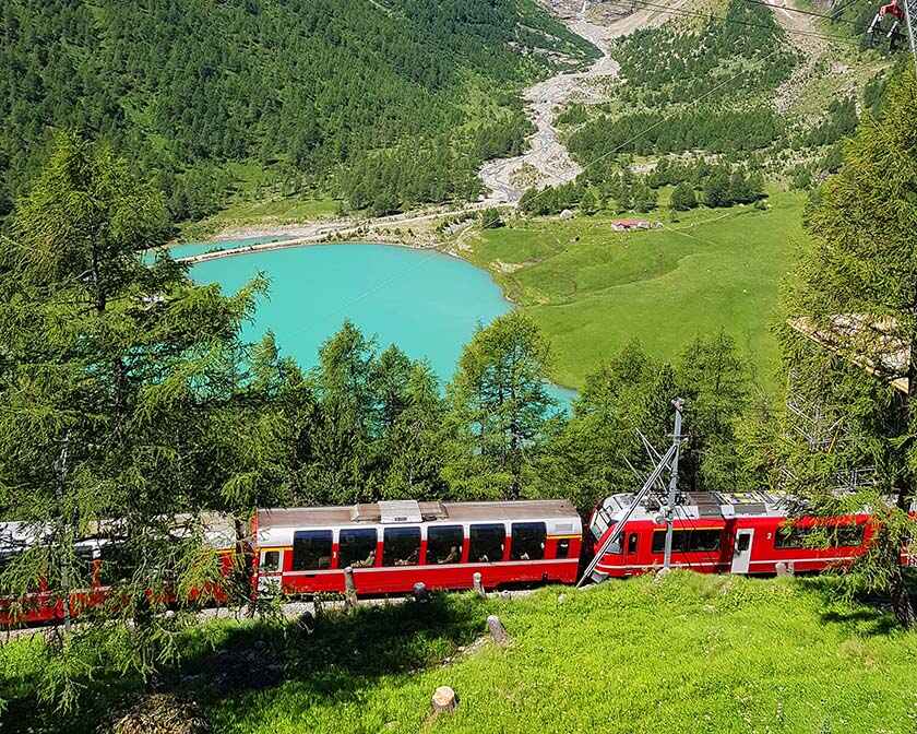 Swiss mountain train Bernina Express crossed Alps with glaciers in the summer