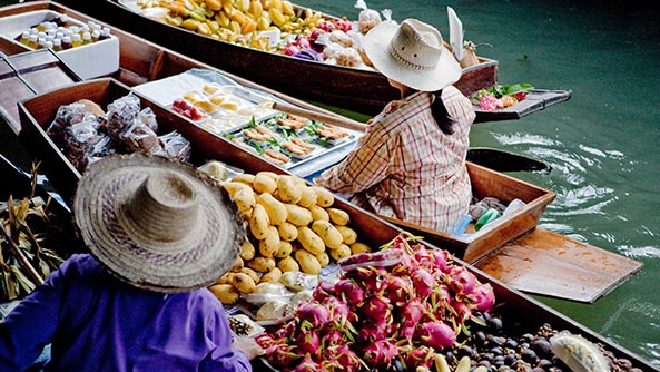Floating market sellers in Thailand.