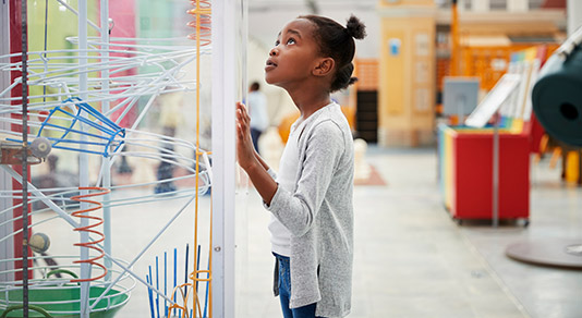 Young girl looking at science exhibit