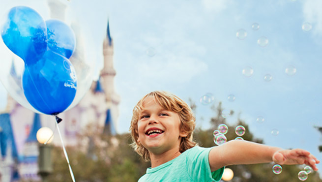 Boy holding Mickey balloon