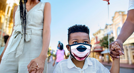 Boy wearing mask at Disneyland