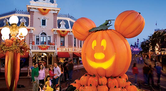 Walt Disney World Resort Florida, a family standing in front of a gigantic pumpkin carving of Mickey Mouse