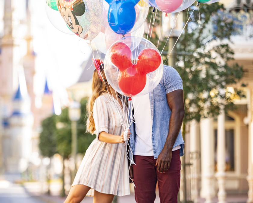 Couple holding balloons