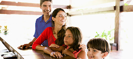 Family of four standing by a reception table