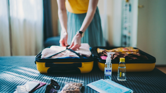Woman packing a suitcase.