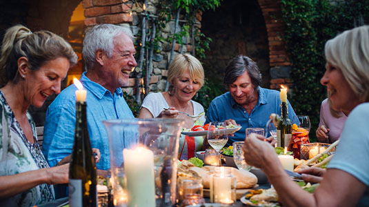 People sitting at a dining table enjoying a meal