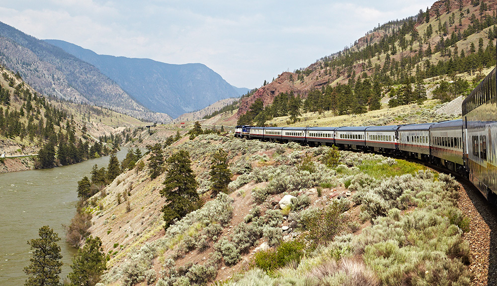 A train going through the rocky mountains.
